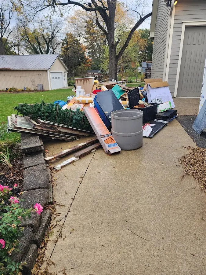 Dumpster being loaded with debris for Commercial Dumpster Rental in Warrensburg